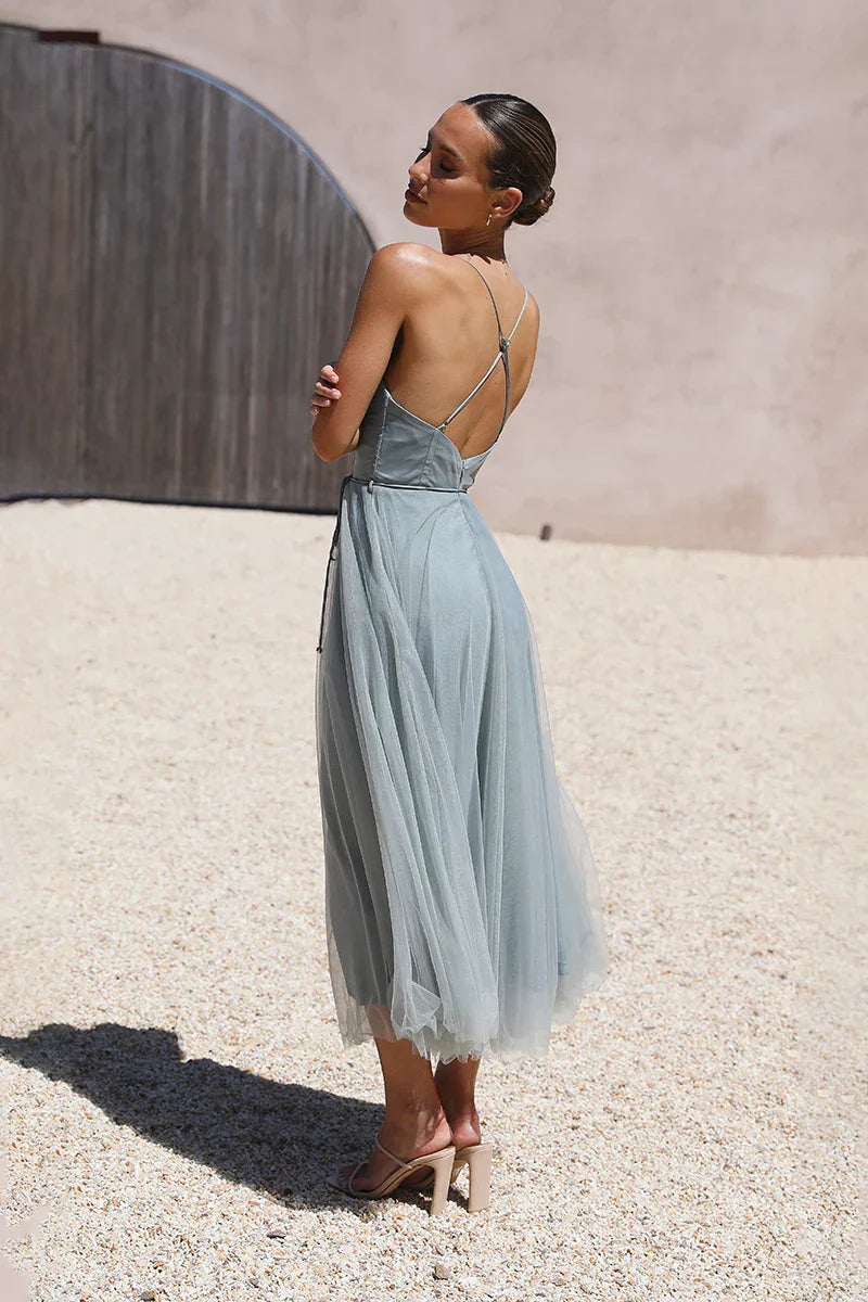 Woman in sage green tulle midi dress
