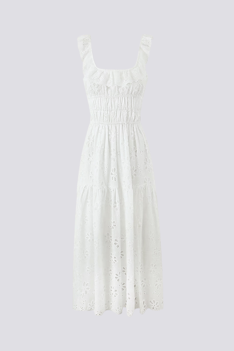 Woman in white eyelet maxi dress with ruffle sleeves