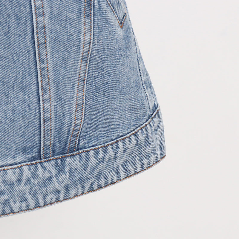 Woman wearing light wash denim skort with button detail