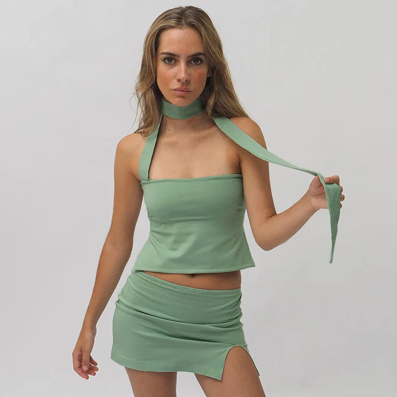 Woman in chocolate brown ribbed knit one-shoulder top and mini skirt.