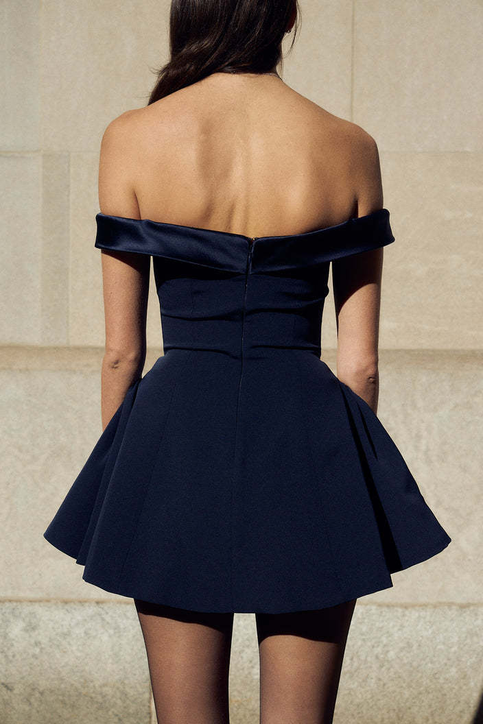 Woman in red off-the-shoulder satin mini dress.