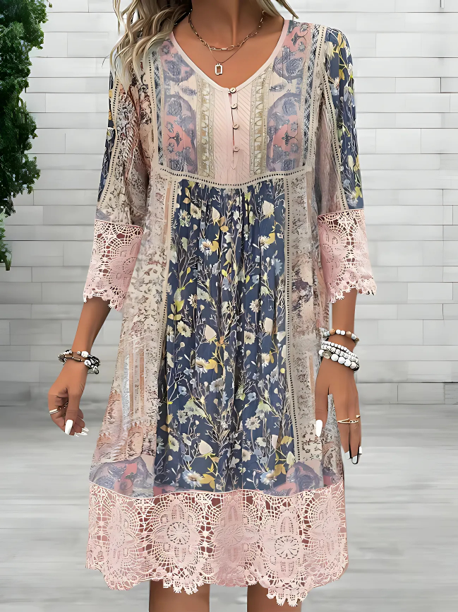 White - A woman wearing a bohemian-style mixed floral patchwork sundress with three-quarter sleeves, featuring pink crochet lace trim at the cuffs and hem.