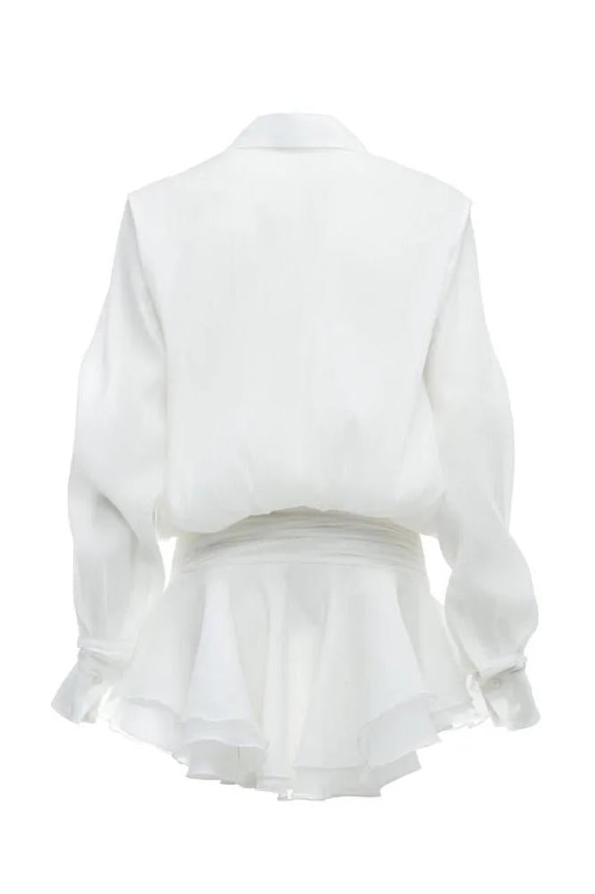 Woman in white sheer chiffon shirt dress with ruffles