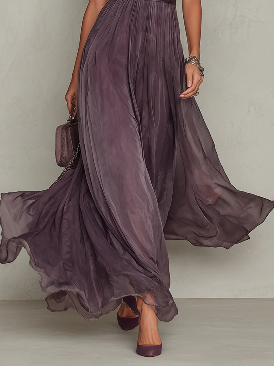 Purple - A woman wearing a flowing, deep mauve pleated chiffon maxi dress with a high keyhole neckline, lace-trimmed puff sleeves, and a banded waist.