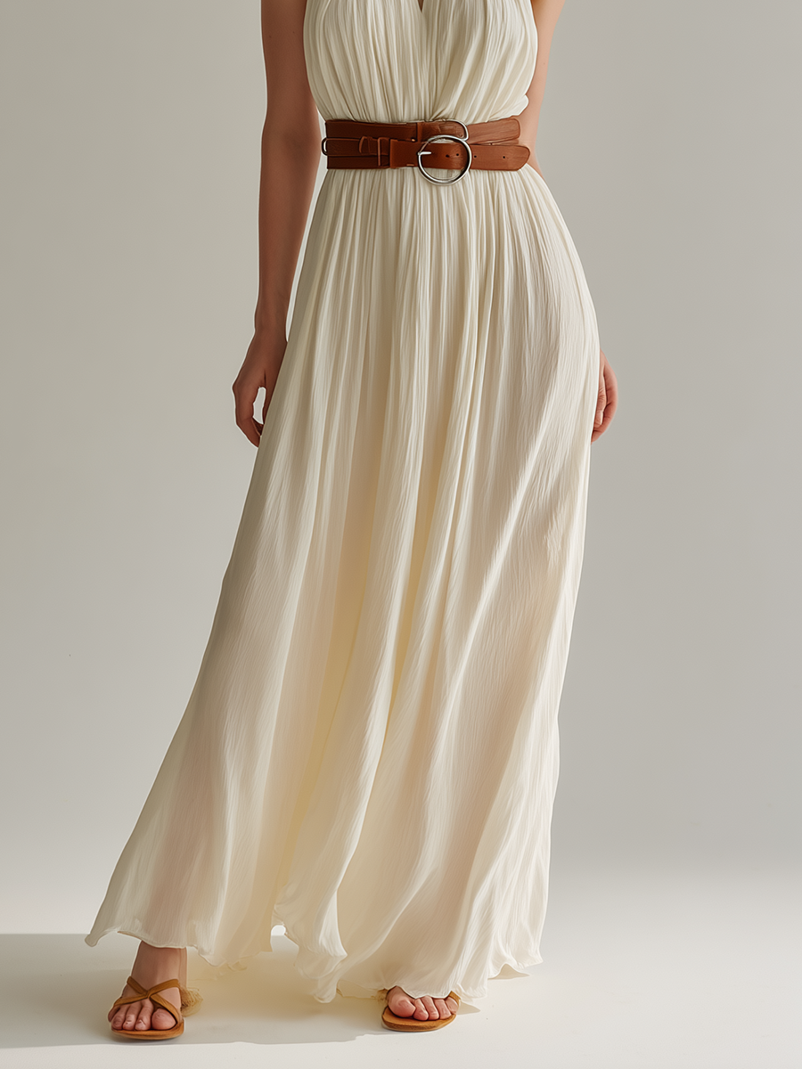 White - Sleeveless floor-length halter maxi dress in finely pleated fabric, styled with a double-wrap brown leather belt.