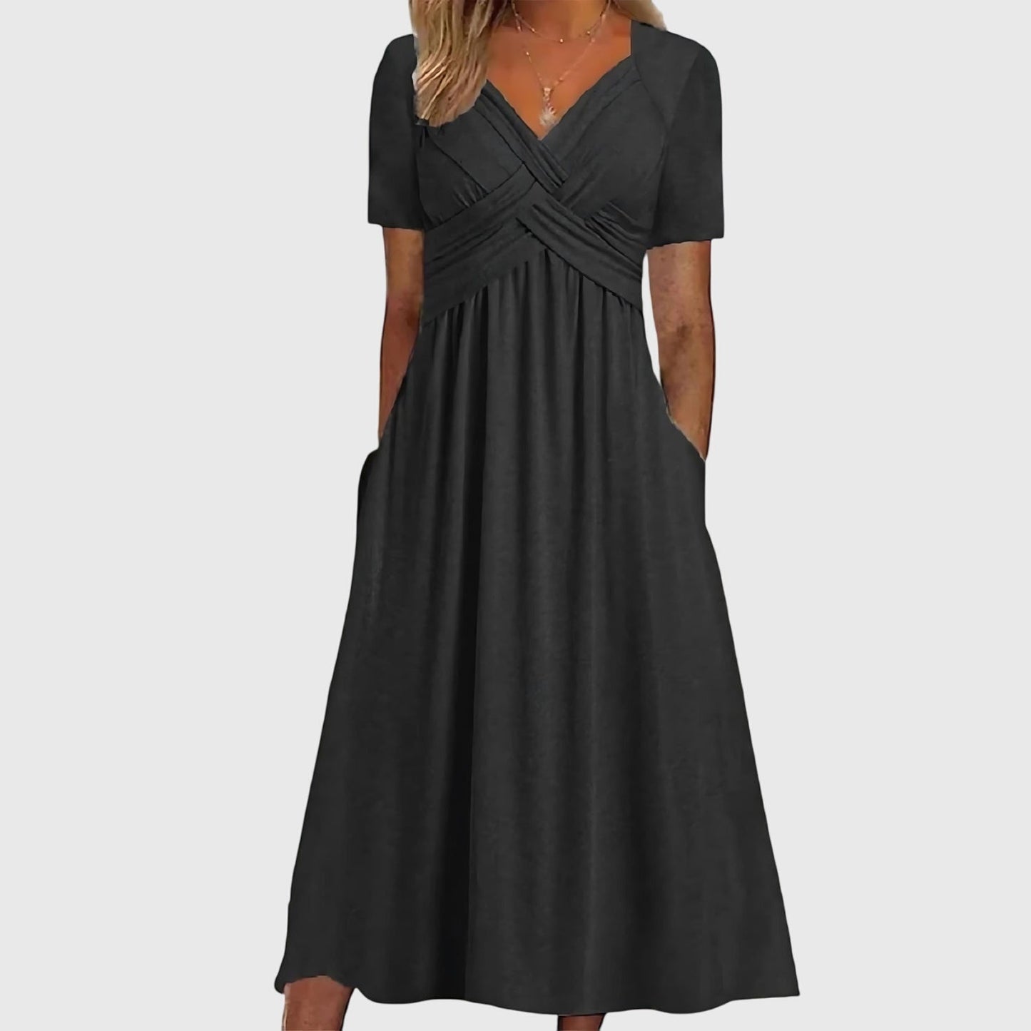 Black - A woman wearing a cornflower blue midi-length jersey dress featuring a criss-cross ruched bodice, short sleeves, and a flowy skirt with side pockets.