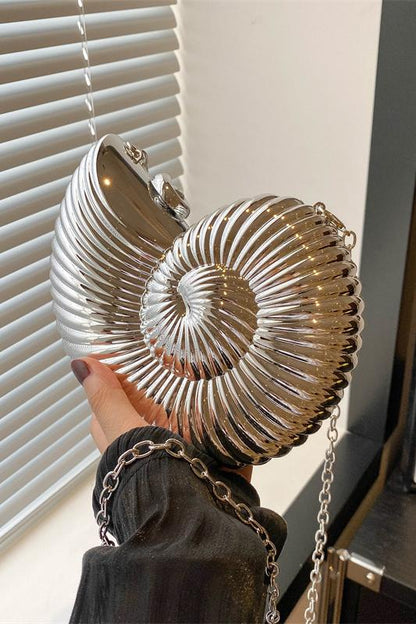 Three metallic shell-shaped clutches in silver, gold, and rose gold