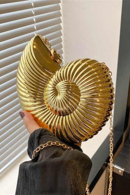 Three metallic shell-shaped clutches in silver, gold, and rose gold