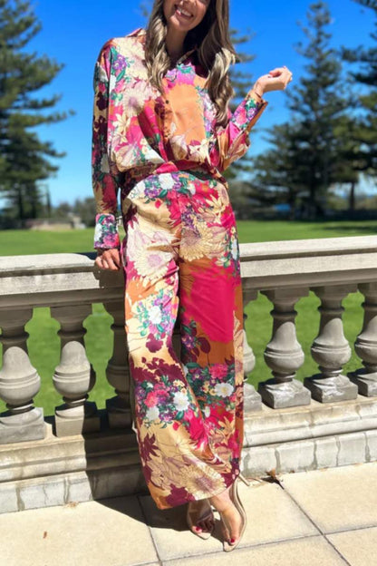Woman in floral satin pantsuit standing on patio