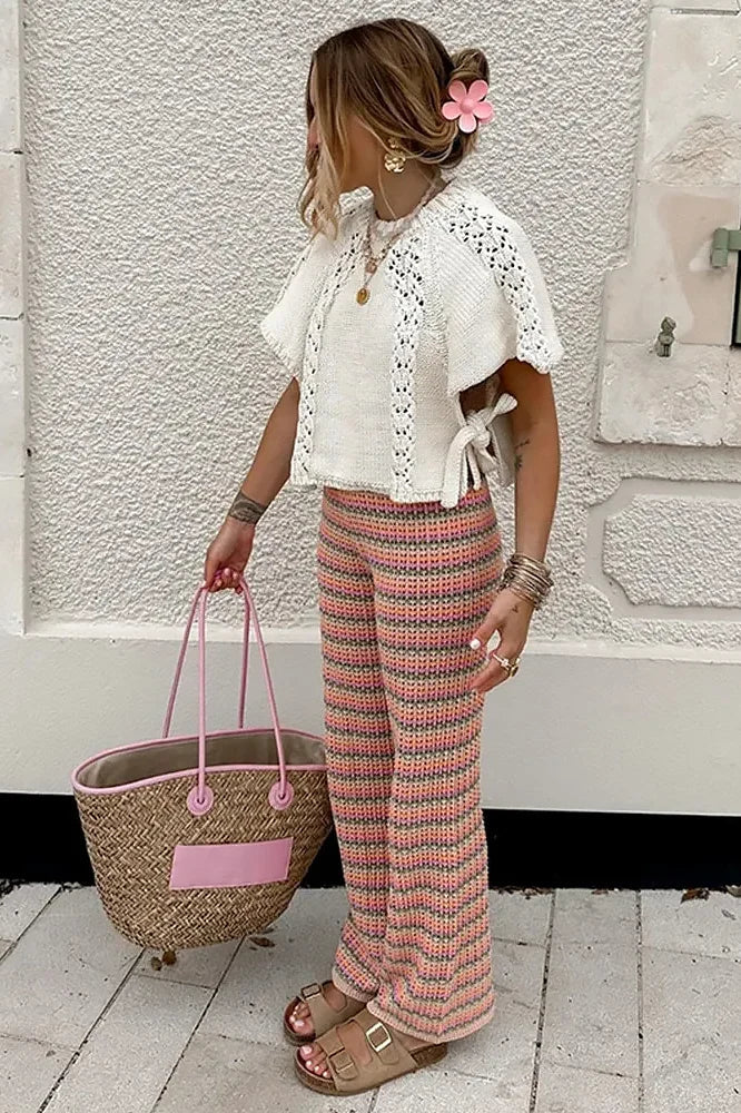 Woman in ivory crochet poncho with patterned pants
