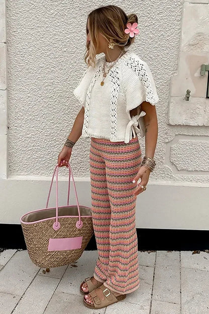 Woman in ivory crochet poncho with patterned pants