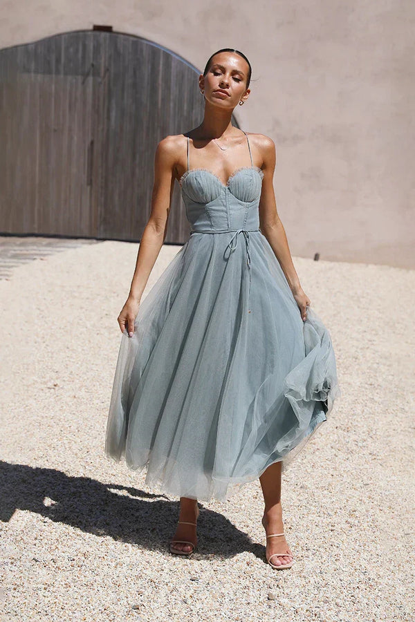 Woman in sage green tulle midi dress