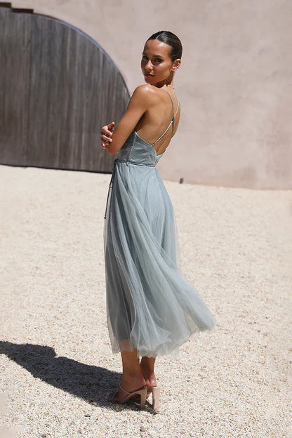 Woman in sage green tulle midi dress