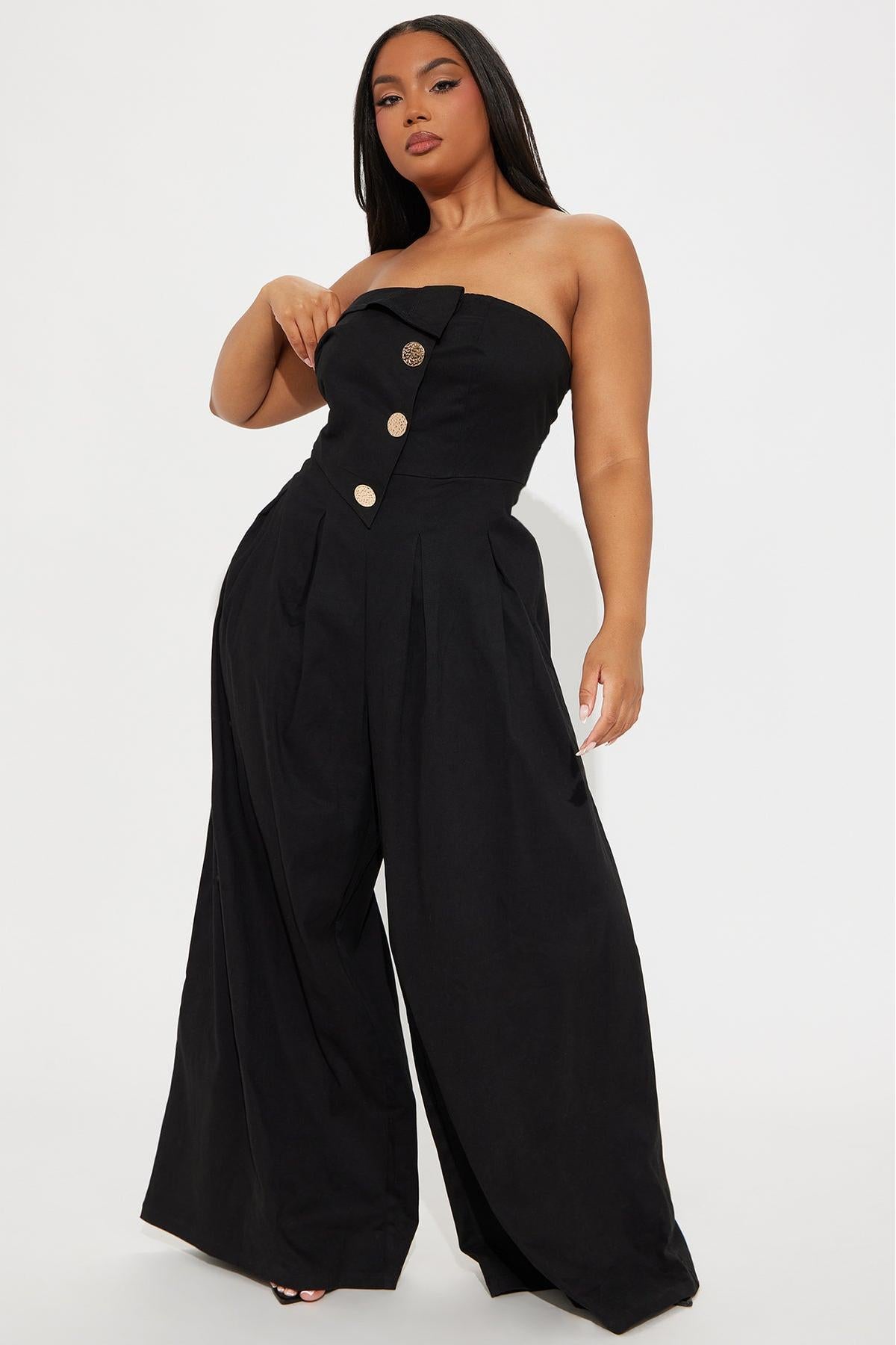 Woman in black one-shoulder woven jumpsuit with gold buttons