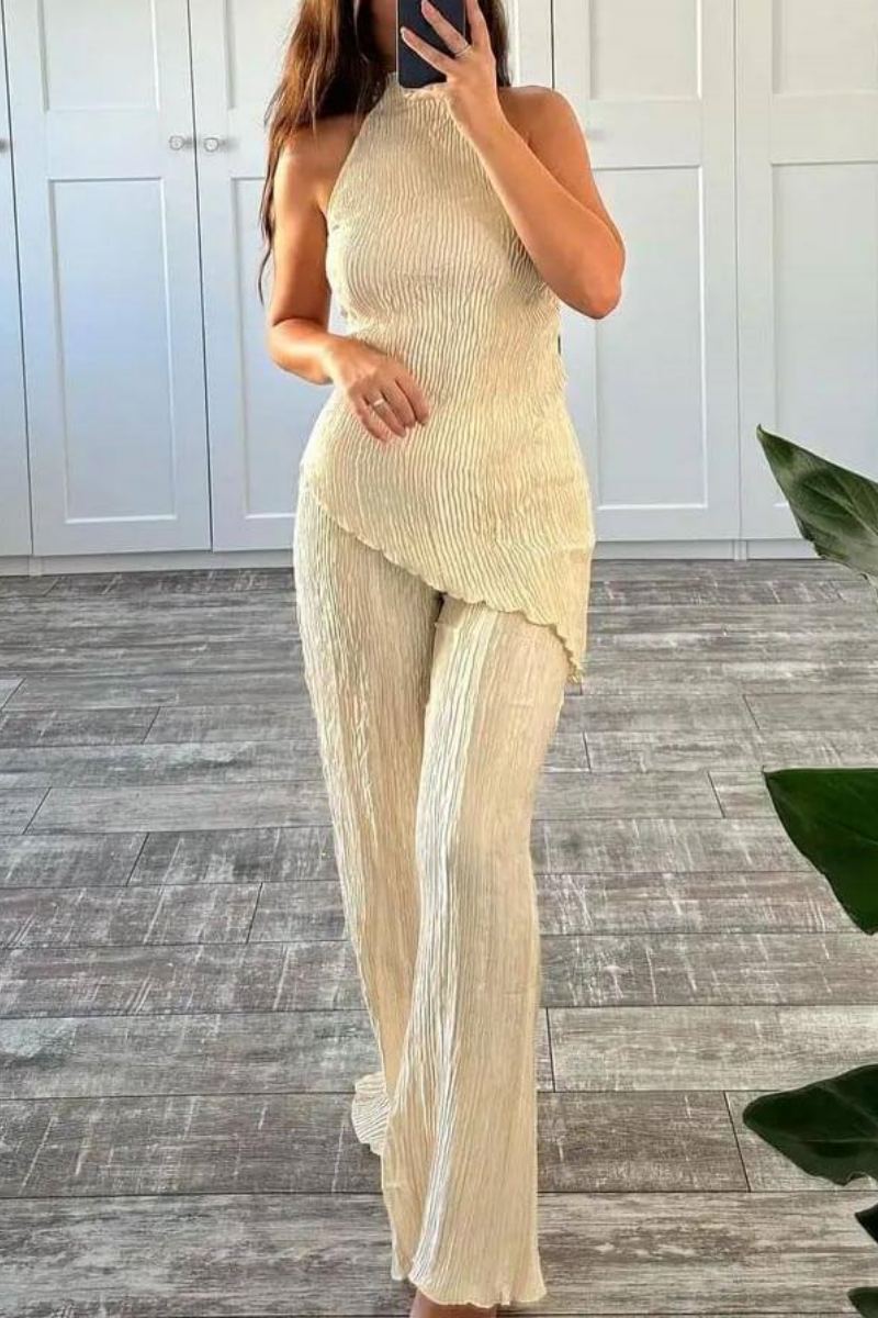 Woman in cream ribbed knit halter top and wide leg pants set.