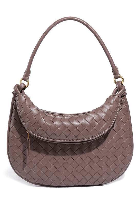 Woman holding dark brown woven leather hobo bag