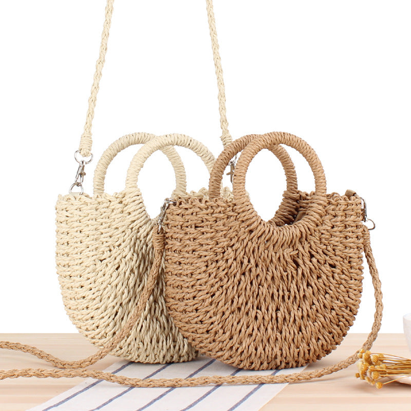 Woven straw handbag with round handle and braided strap