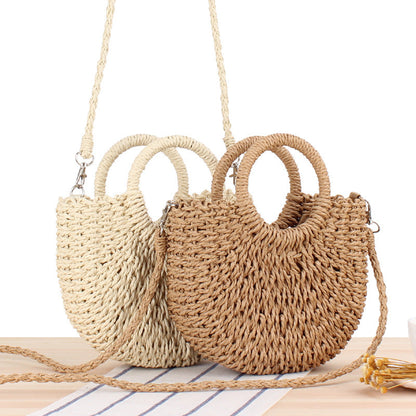 Woven straw handbag with round handle and braided strap