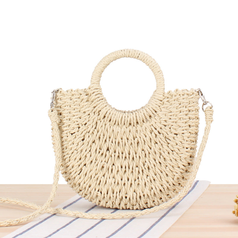 Woven straw handbag with round handle and braided strap