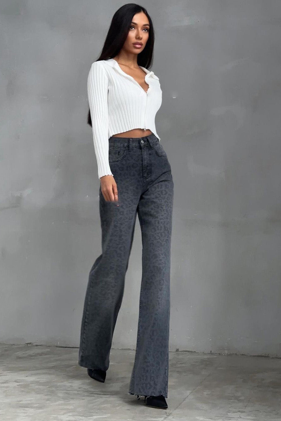 Woman in gray leopard print wide leg jeans and white ribbed knit top