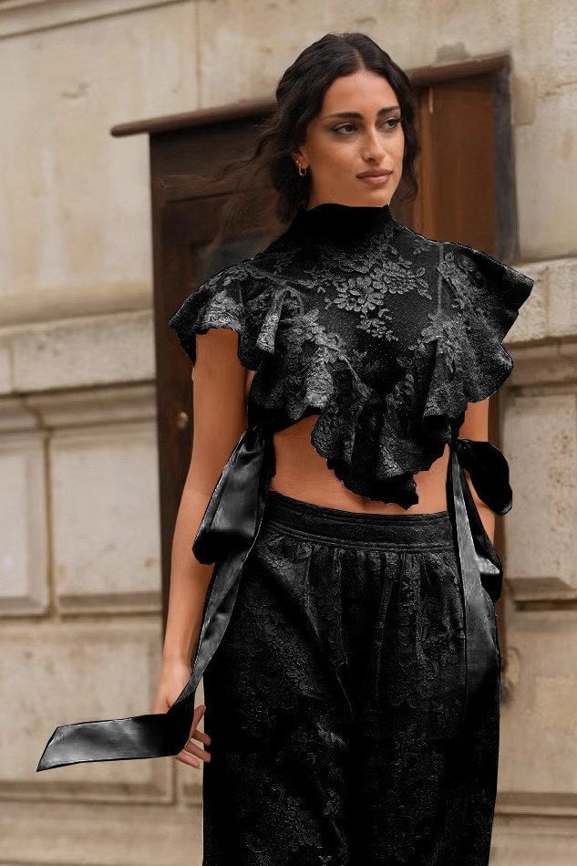 Woman in cream lace crop top and jeans on city street
