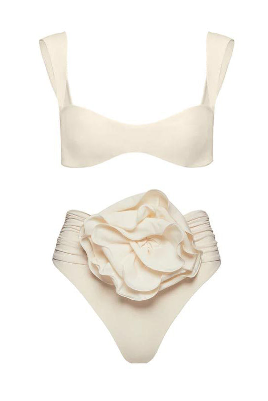 Woman in ivory textured high-waisted swimsuit with large floral detail