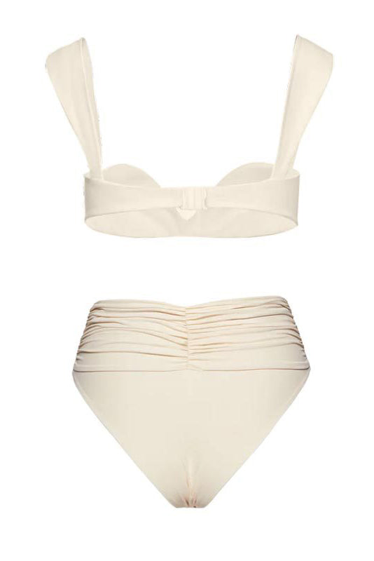 Woman in ivory textured high-waisted swimsuit with large floral detail