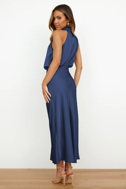 Woman in navy blue satin halter midi dress