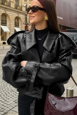 Woman in burgundy faux leather oversized jacket with matching headband and purse