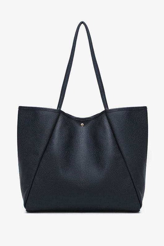 Front view of black textured tote bag with top handles and gold button detail