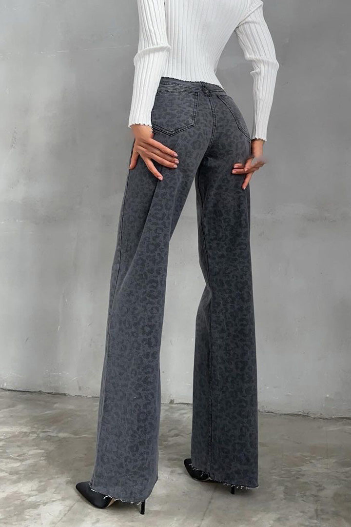 Woman in gray leopard print wide leg jeans and white ribbed knit top