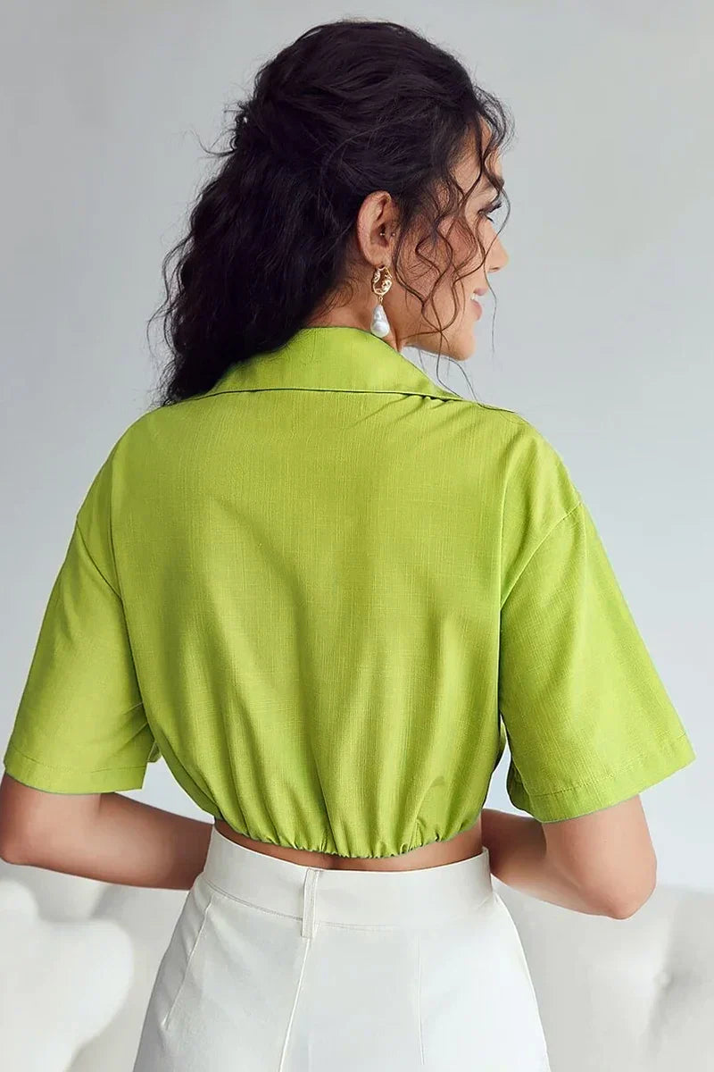 Woman wearing lime green cotton crop top with twisted front