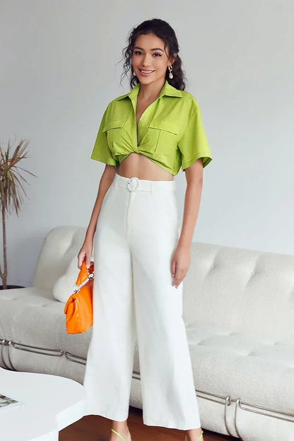 Woman wearing lime green cotton crop top with twisted front
