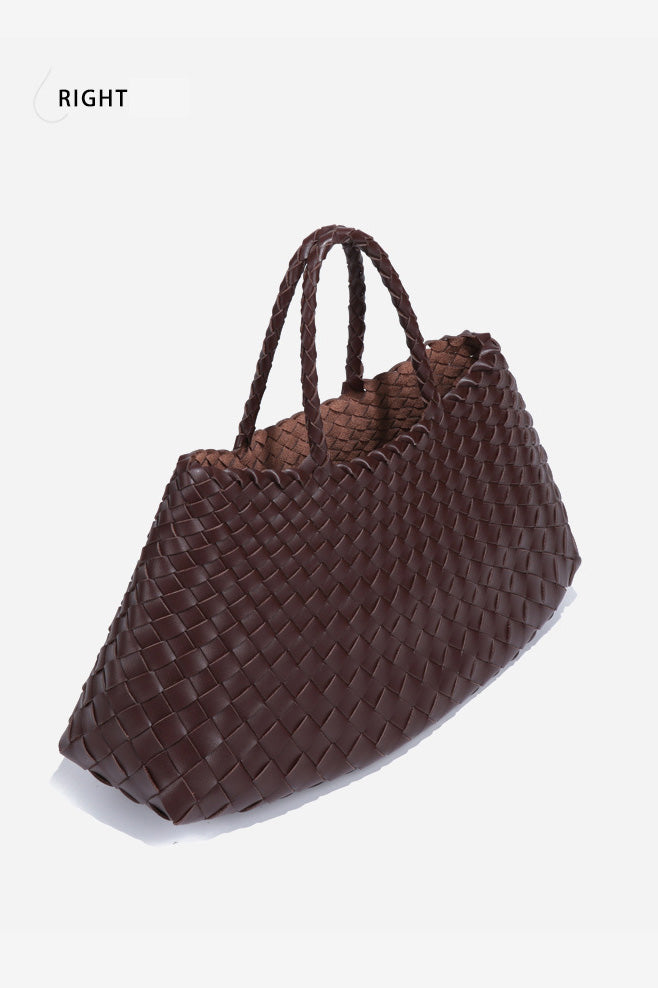 Woman holding brown woven tote bag