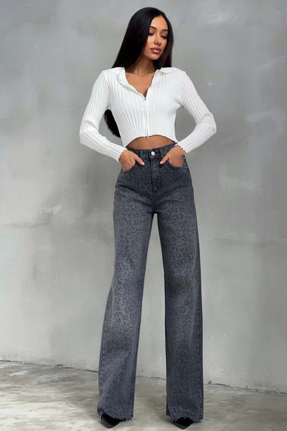 Woman in gray leopard print wide leg jeans and white ribbed knit top