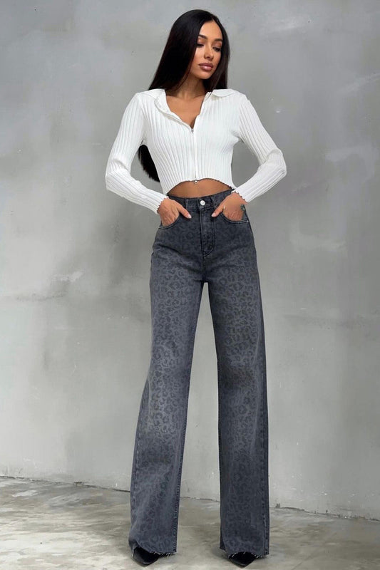 Woman in gray leopard print wide leg jeans and white ribbed knit top