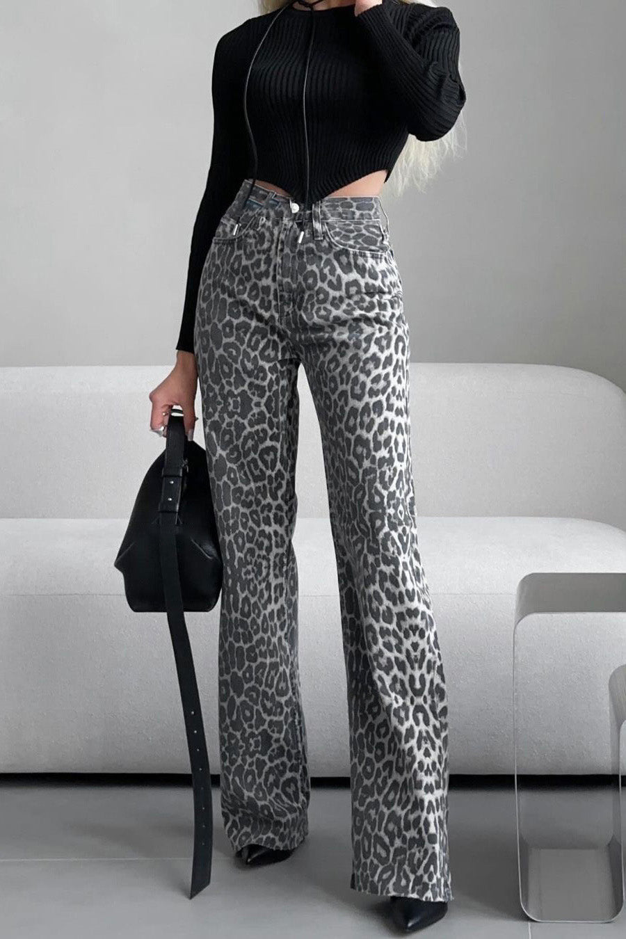 Woman in gray leopard print wide leg jeans and white ribbed knit top