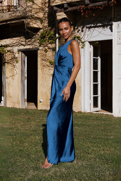 Woman in rust satin maxi dress with twisted bodice