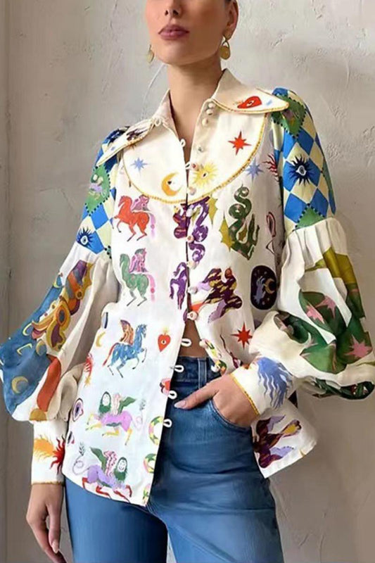 Woman wearing a white linen blouse with a colorful celestial print and balloon sleeves.