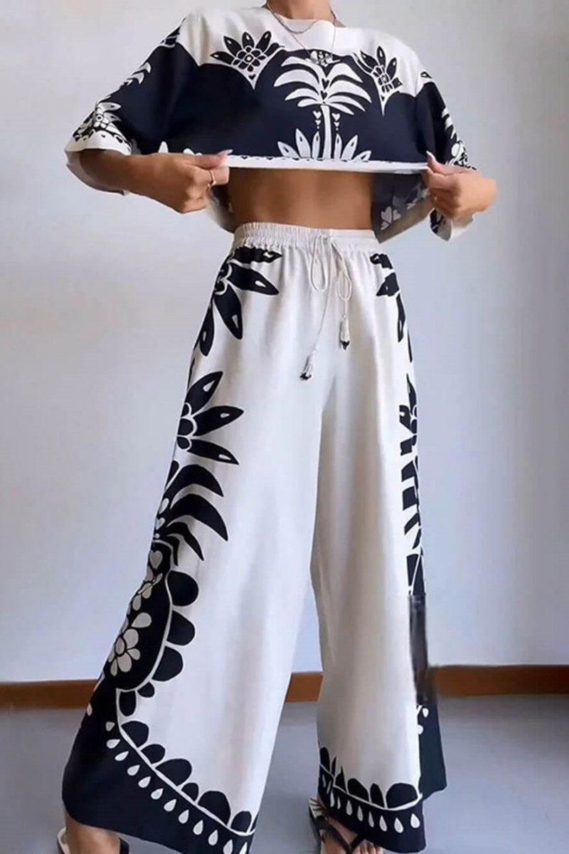 Woman wearing cream and black linen pant set with floral print