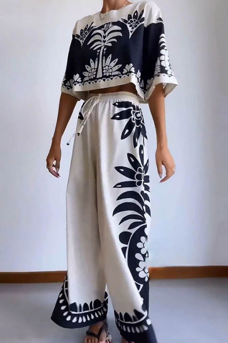 Woman wearing cream and black linen pant set with floral print