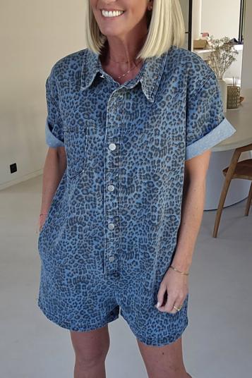 Woman wearing a blue leopard print denim romper.