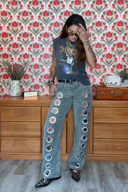 Woman wearing gray acid wash jeans with grommets