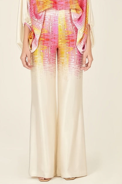 Woman wearing ivory, pink, and yellow satin two-piece set.