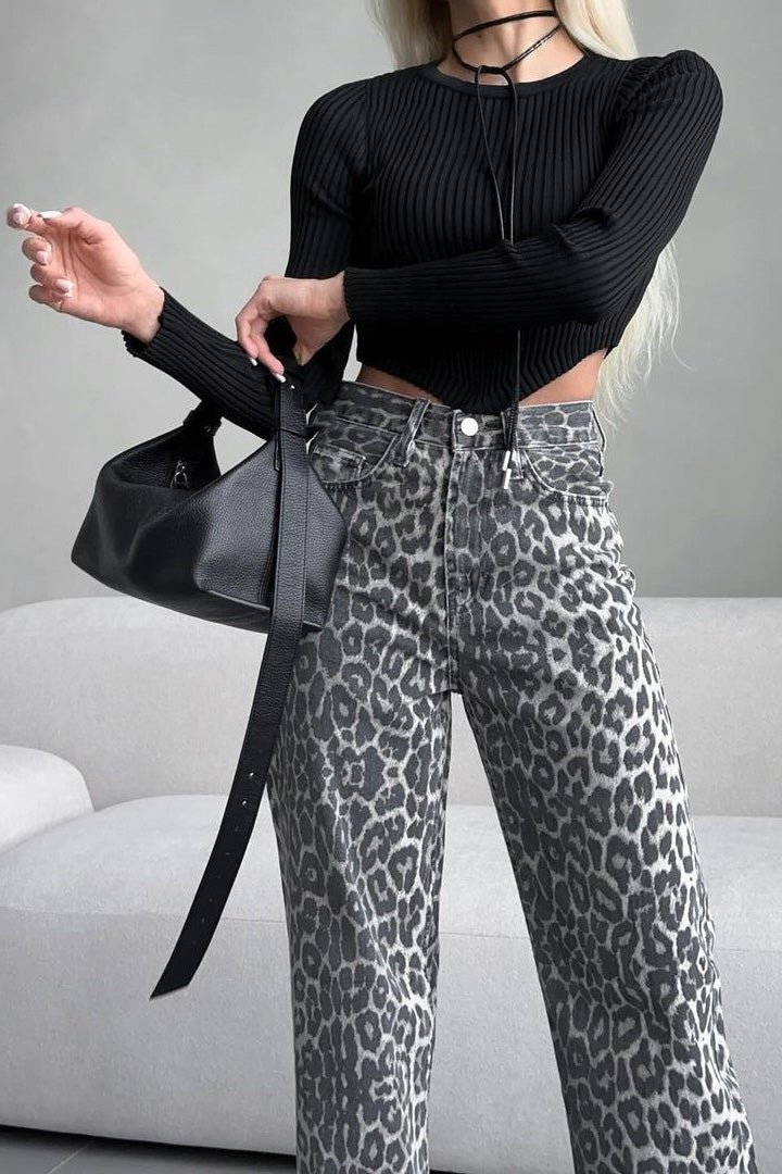 Woman in gray leopard print wide leg jeans and white ribbed knit top
