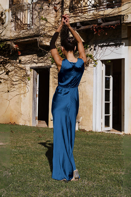 Woman in rust satin maxi dress with twisted bodice