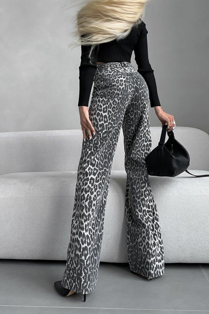 Woman in gray leopard print wide leg jeans and white ribbed knit top