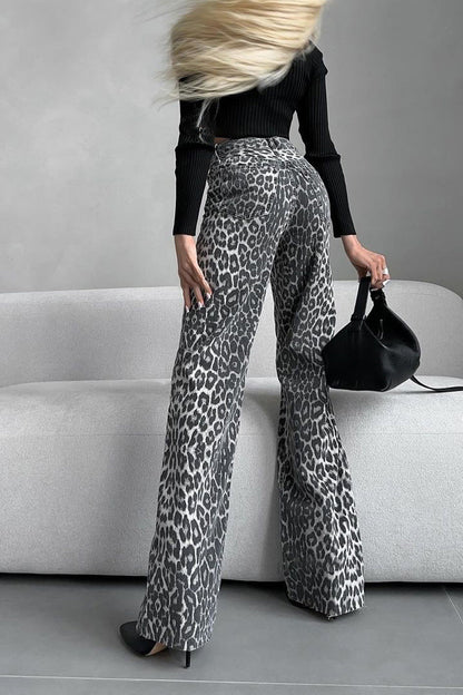Woman in gray leopard print wide leg jeans and white ribbed knit top
