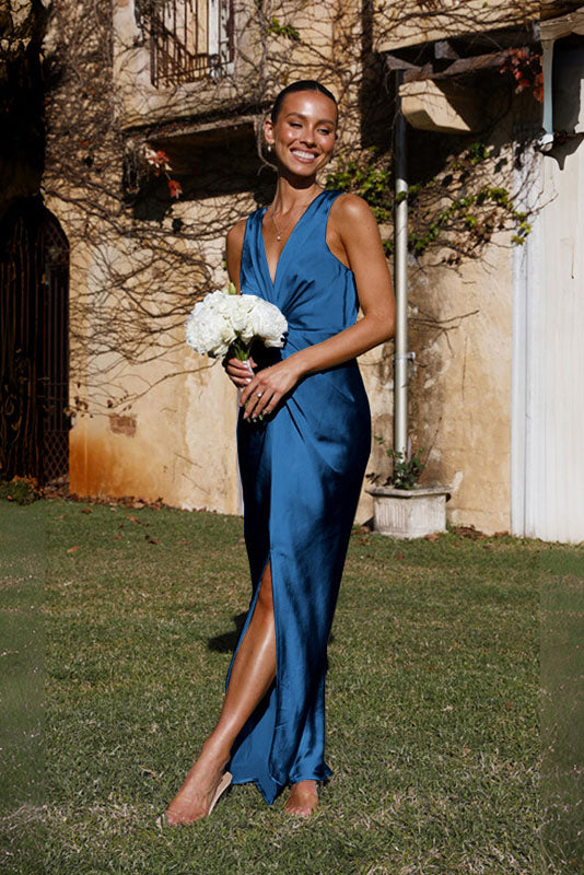 Woman in rust satin maxi dress with twisted bodice