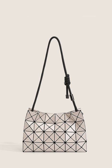 Ivory geometric panel bucket bag with black knotted shoulder strap